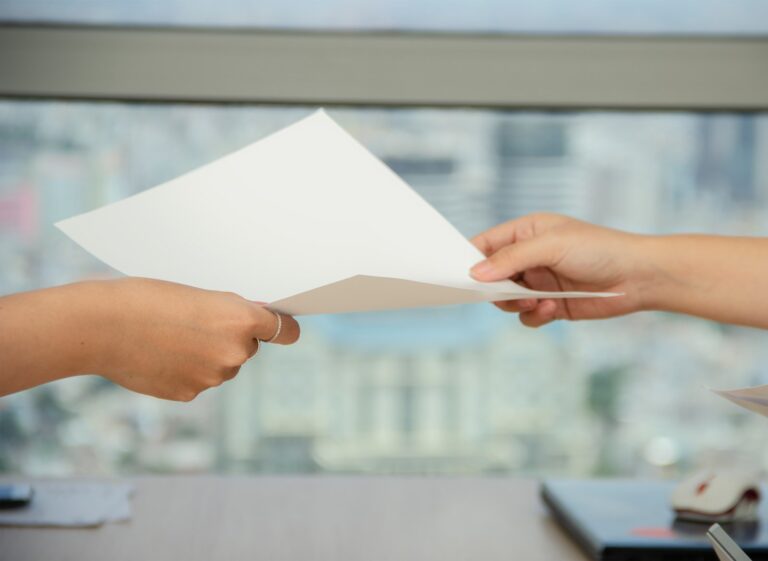 person handing over paper