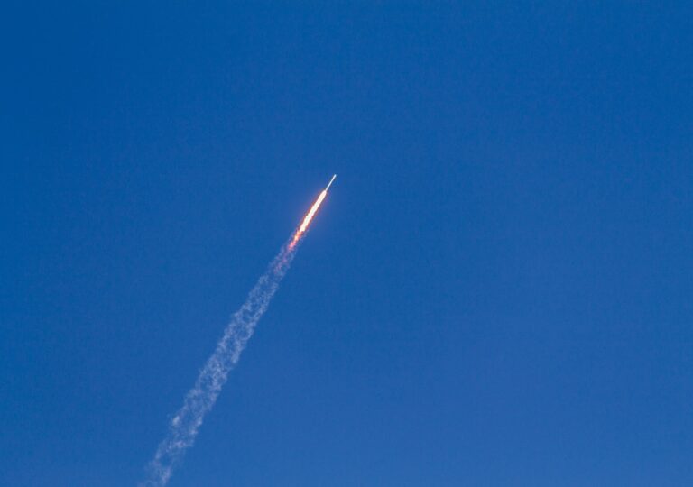 flying rocket during daytime