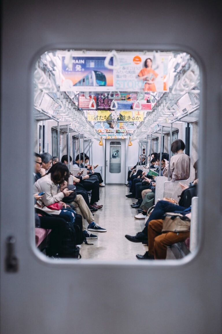 people at the train looking at their phones