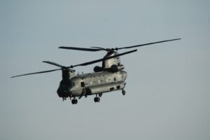 gray helicopter flying in the sky during daytime