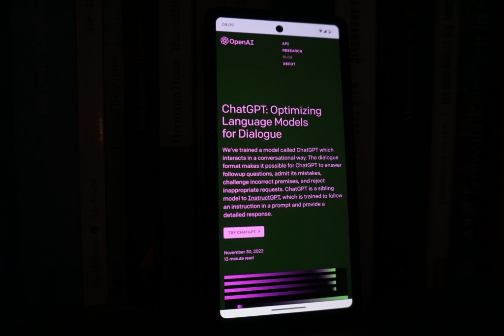 a cell phone with a lit up screen in the dark