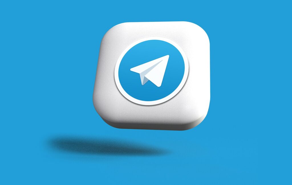 telegram a blue and white square button with a paper airplane on it