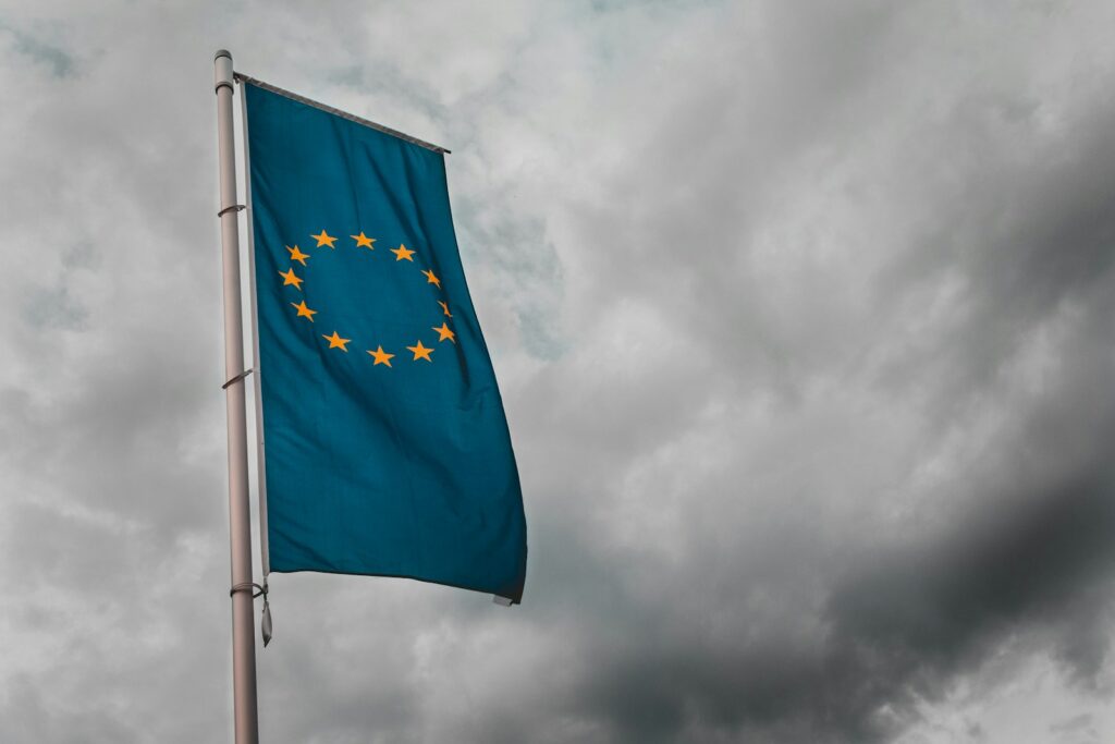 teal flag under cloudy sky